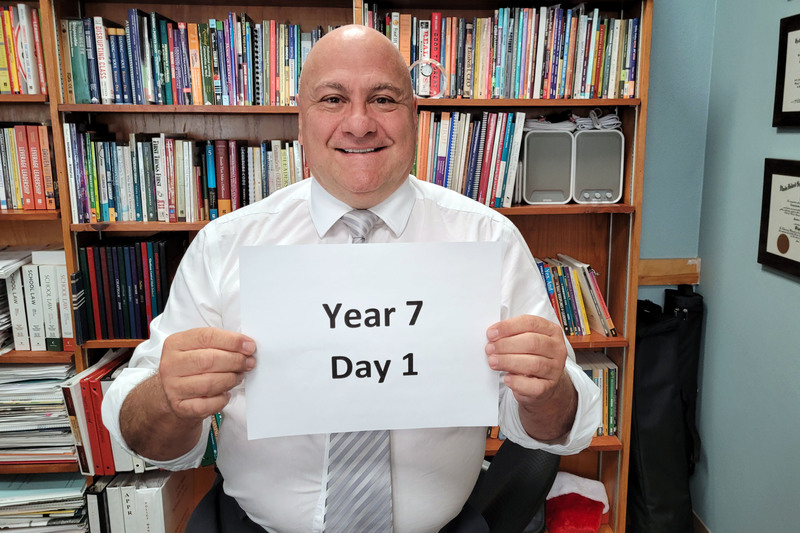 Dr. DeAngelo holding year 7 day 1 sign