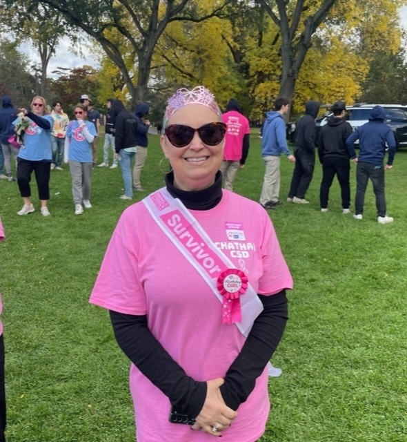 woman wearing pink shirt and survivor sash