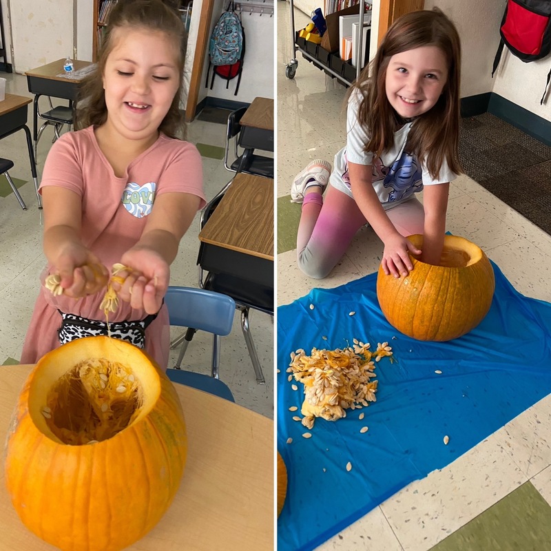 Two girls scooping out pumpkins
