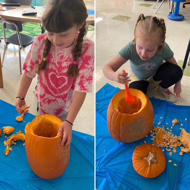 two girls scooping out pumpkins