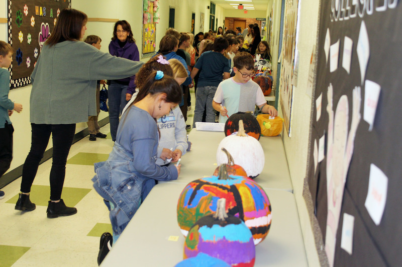 students voting for their favorite pumpkins