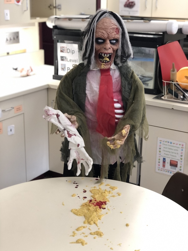 zombie holding arm over spilled patato chips